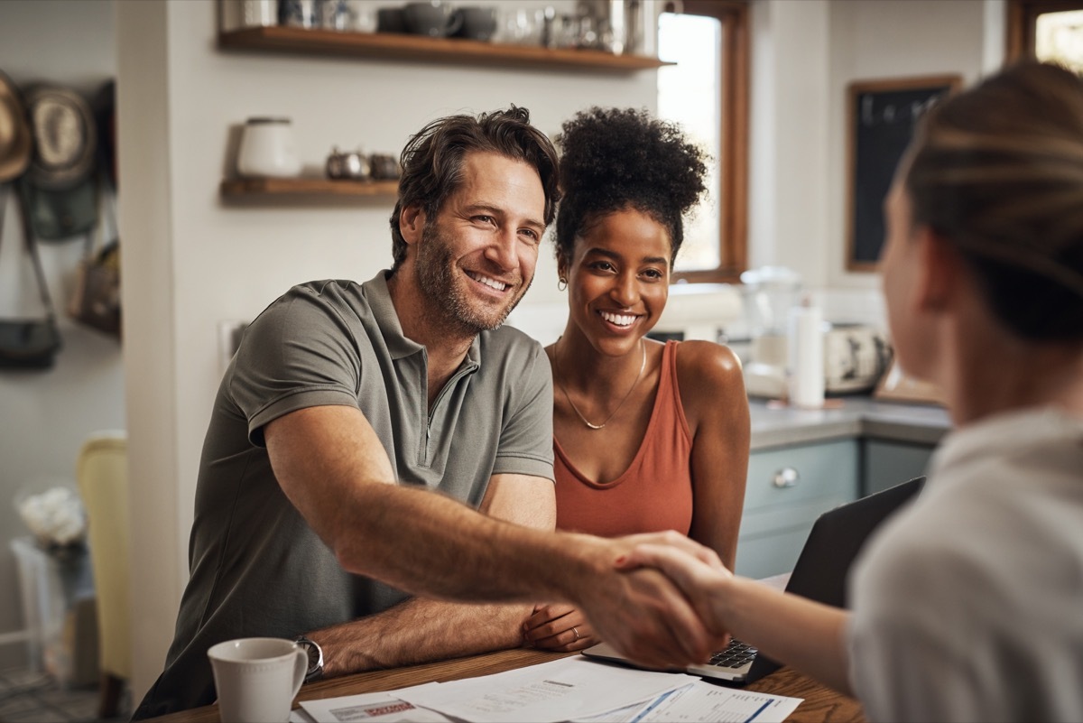 Cropped shot of a handsome middle aged man shaking hands with a financial advisor during a consultation at home