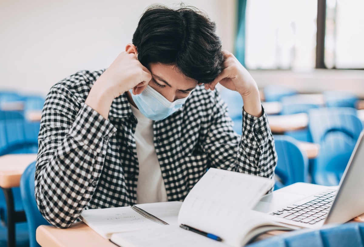 stressed college student near books