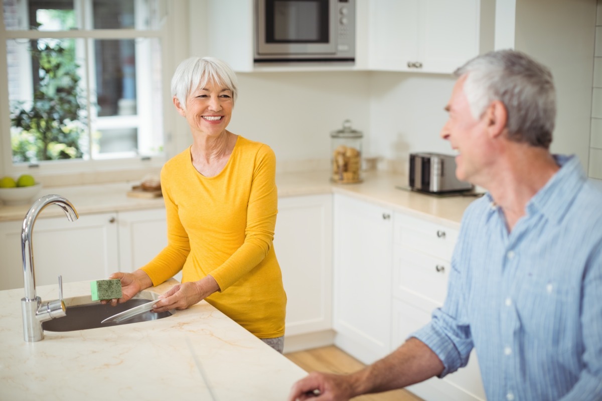 older white straight couple cleaning kitchen