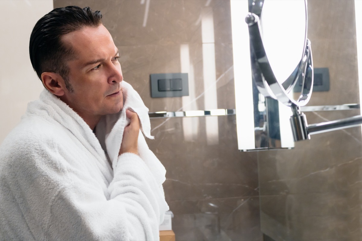 Man drying his face with a towel