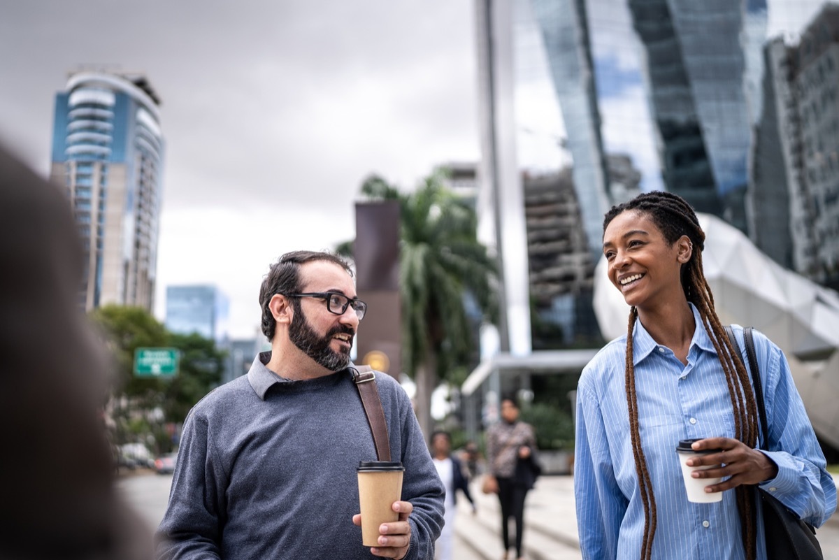 Colleagues walking and talking in a financial district