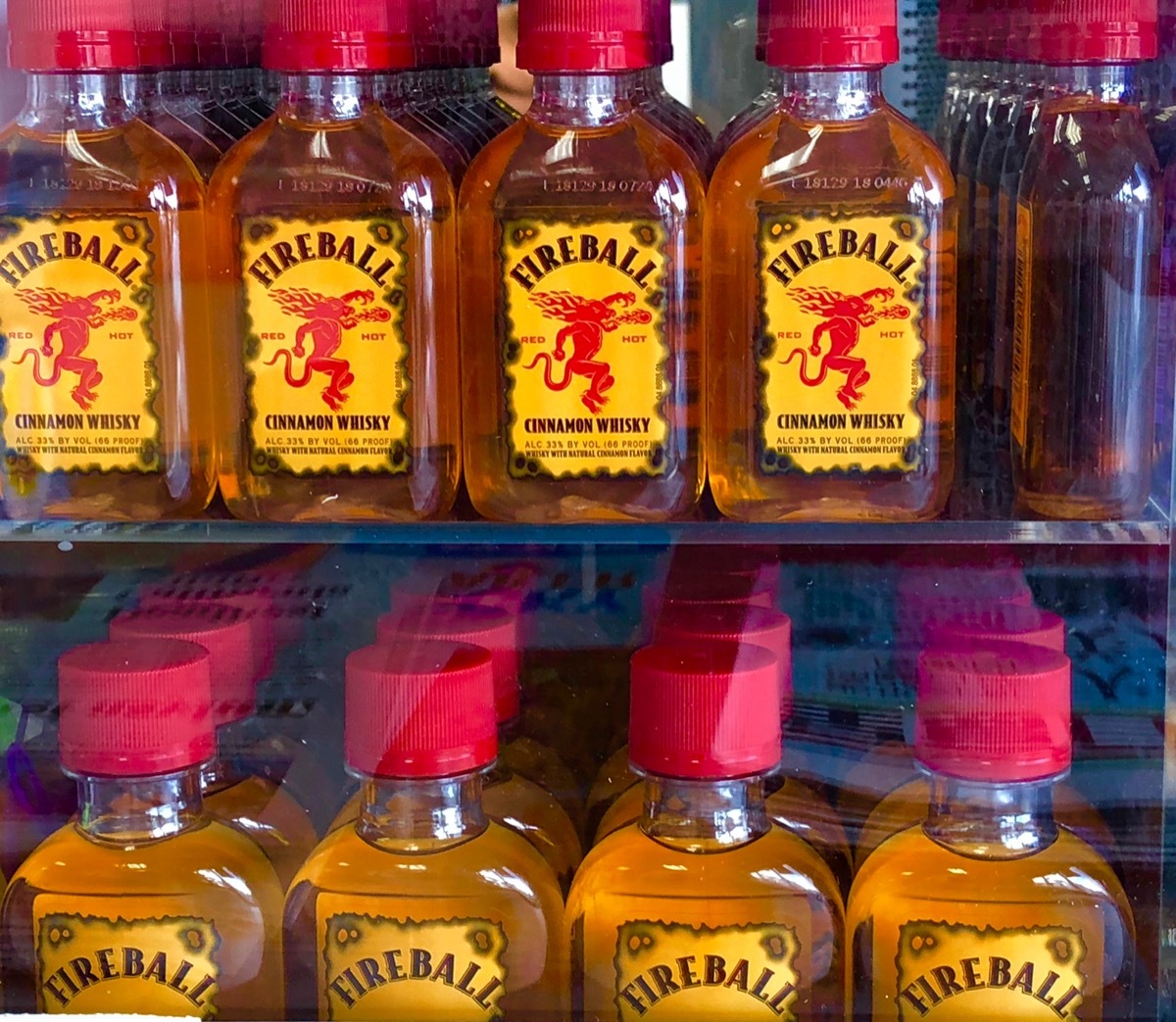 Bottle of mini fireballs on a glass shelf