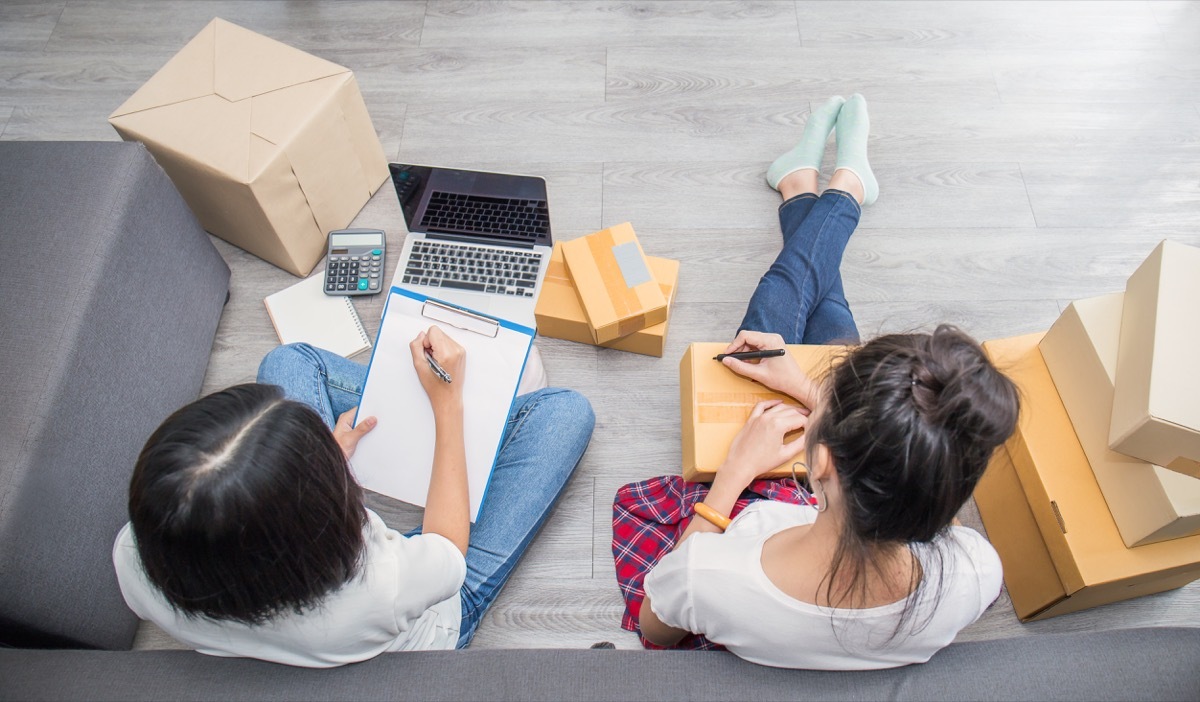 young couple packing items and making list