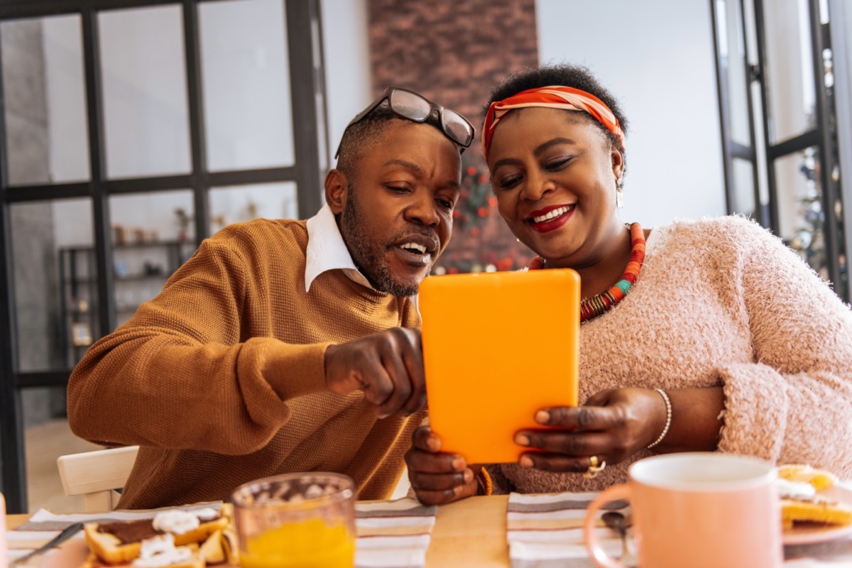 middle age couple looking at tablet