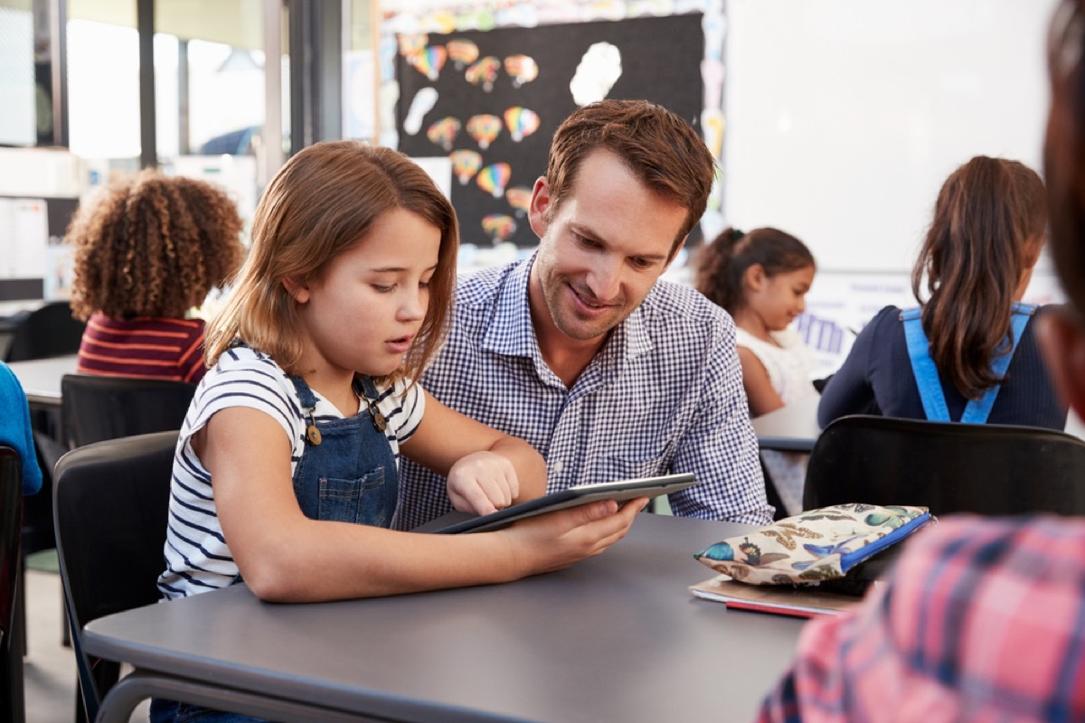 male teacher helping student in classroom, things you should never say to a teacher