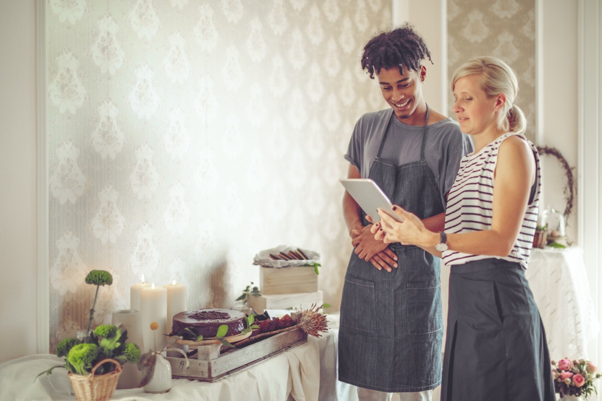 a man and woman planning an event together with cakes