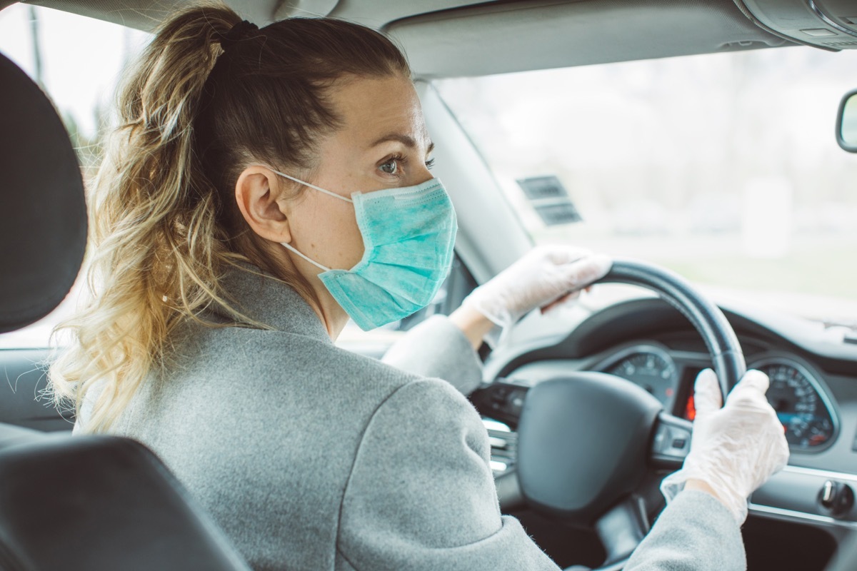 Woman during pandemic isolation at city, she is in car