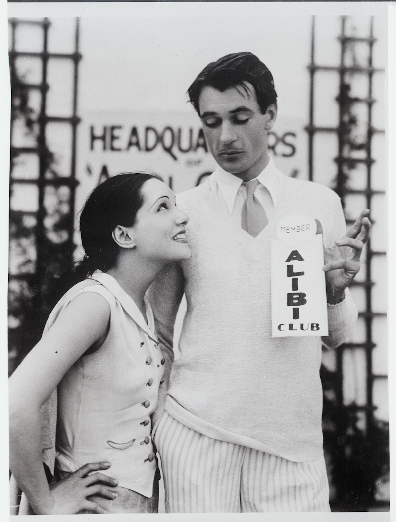 Lupe Vélez and Gary Cooper posing for a photo as Cooper holds an 