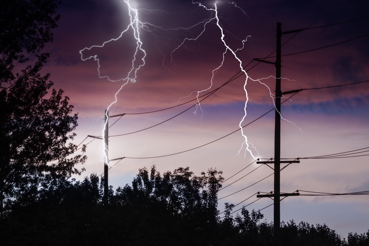 Silhouette of Power Lines being struck by lightning.