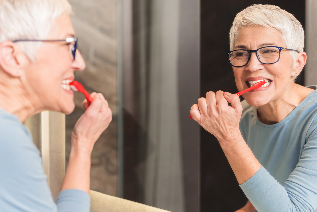 Woman brushing her teeth.