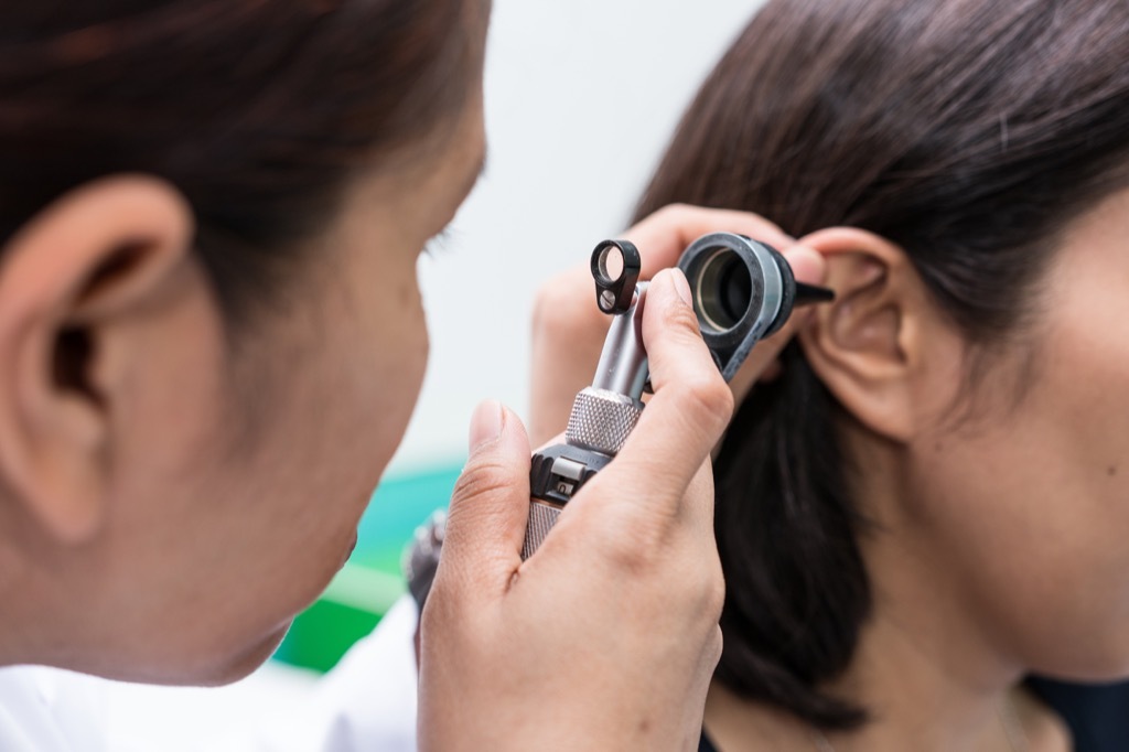 woman's ear examined at doctor's office