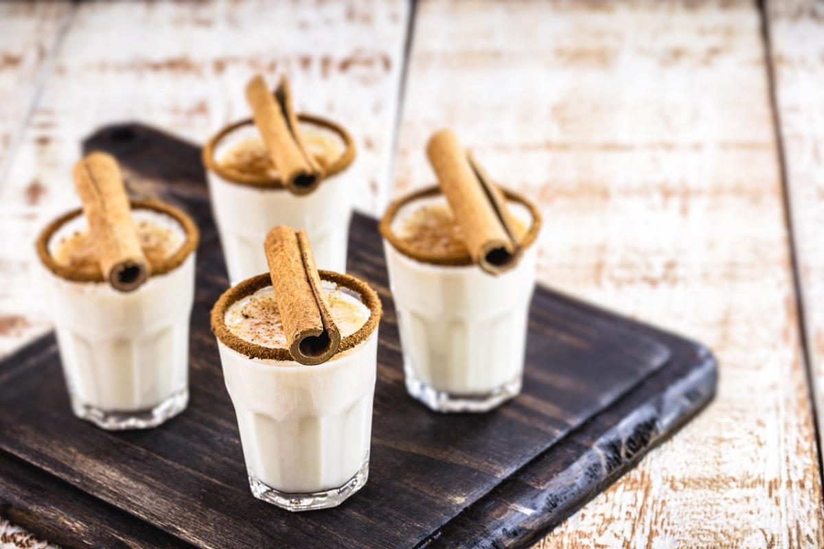 coquito, four small glasses with cinnamon