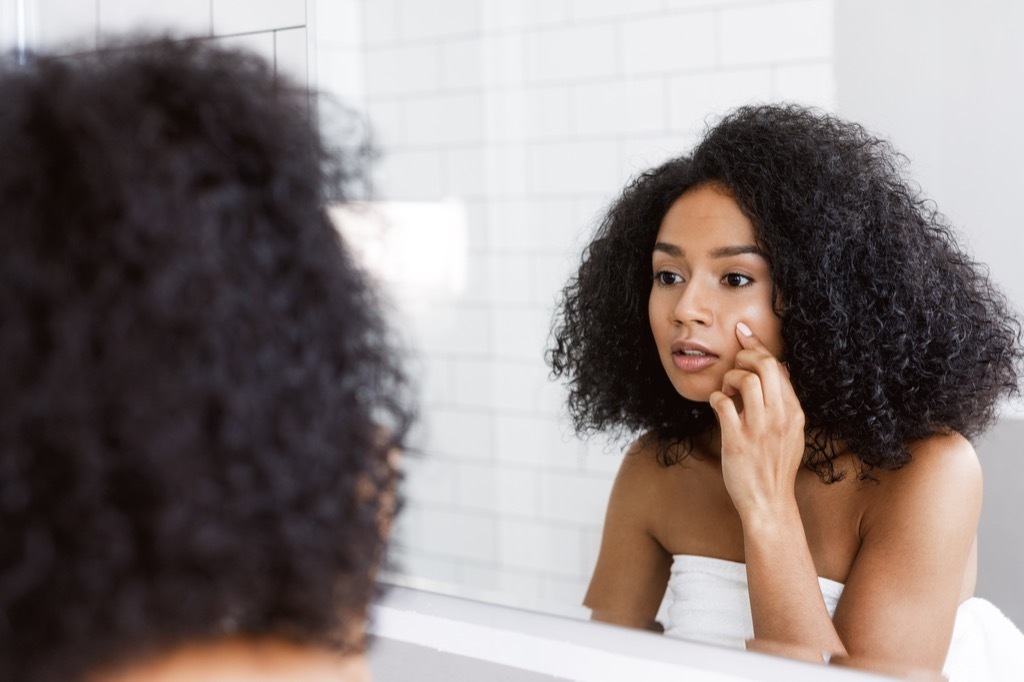 woman looking in mirror