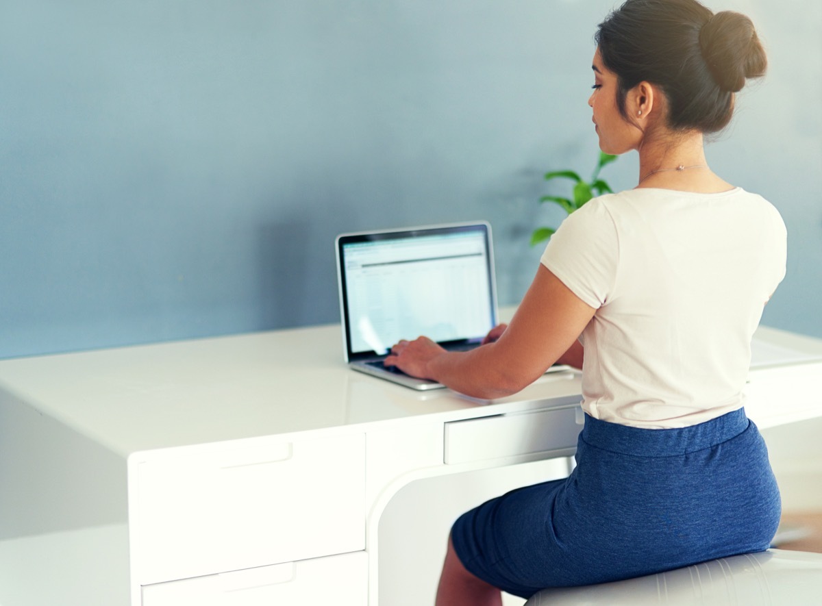 Cropped shot of a young businesswoman working on her laptop at home