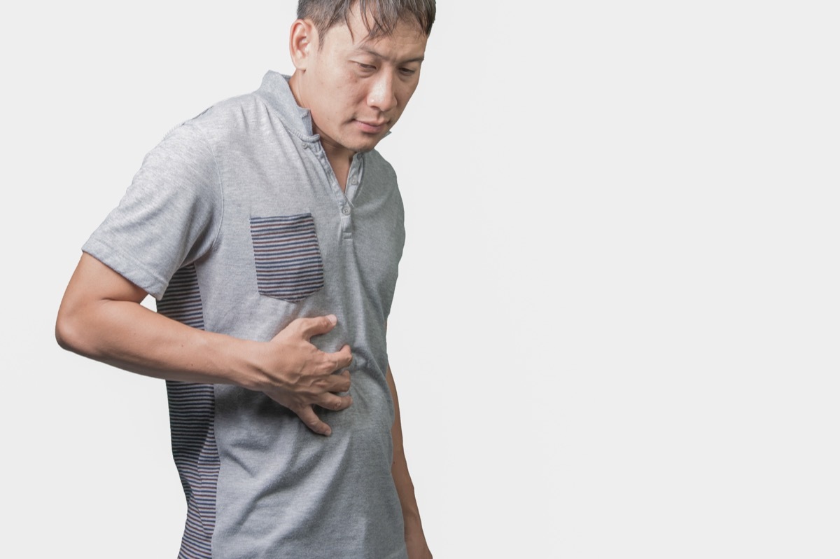 Man holding stomach in pain