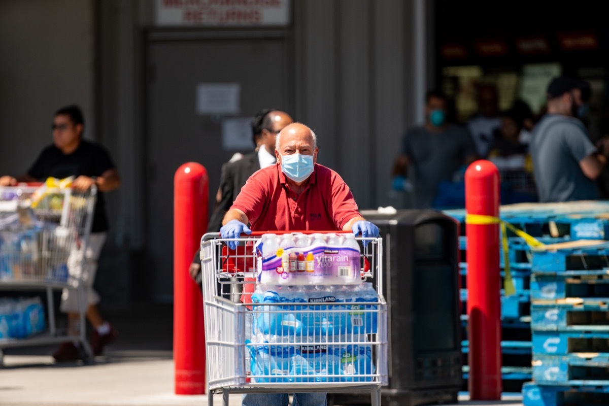 Elderly man stocking up on water due to Covid 19 Coronavirus pandemic crisis Miami FL Costco