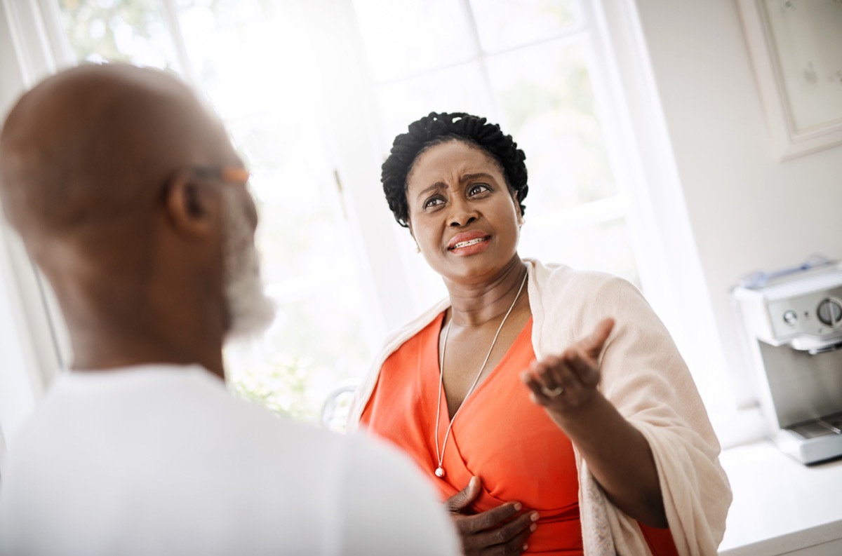 woman gestures at husband in frustration during serious conversation