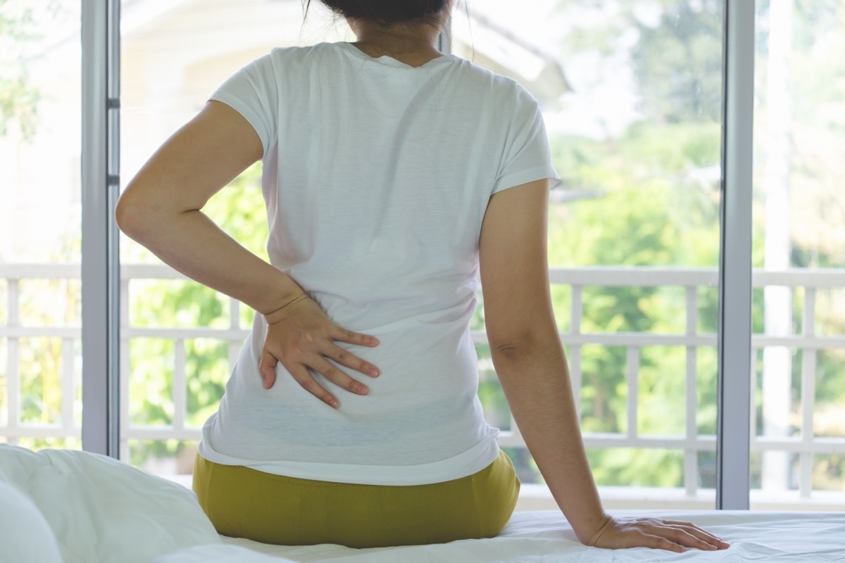 Woman experiencing kidney disease lower back pain