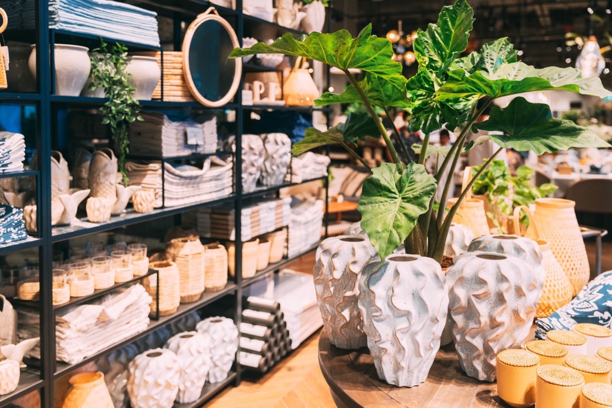 Display of yellow and blue pots and decor at a HomeGoods store. 