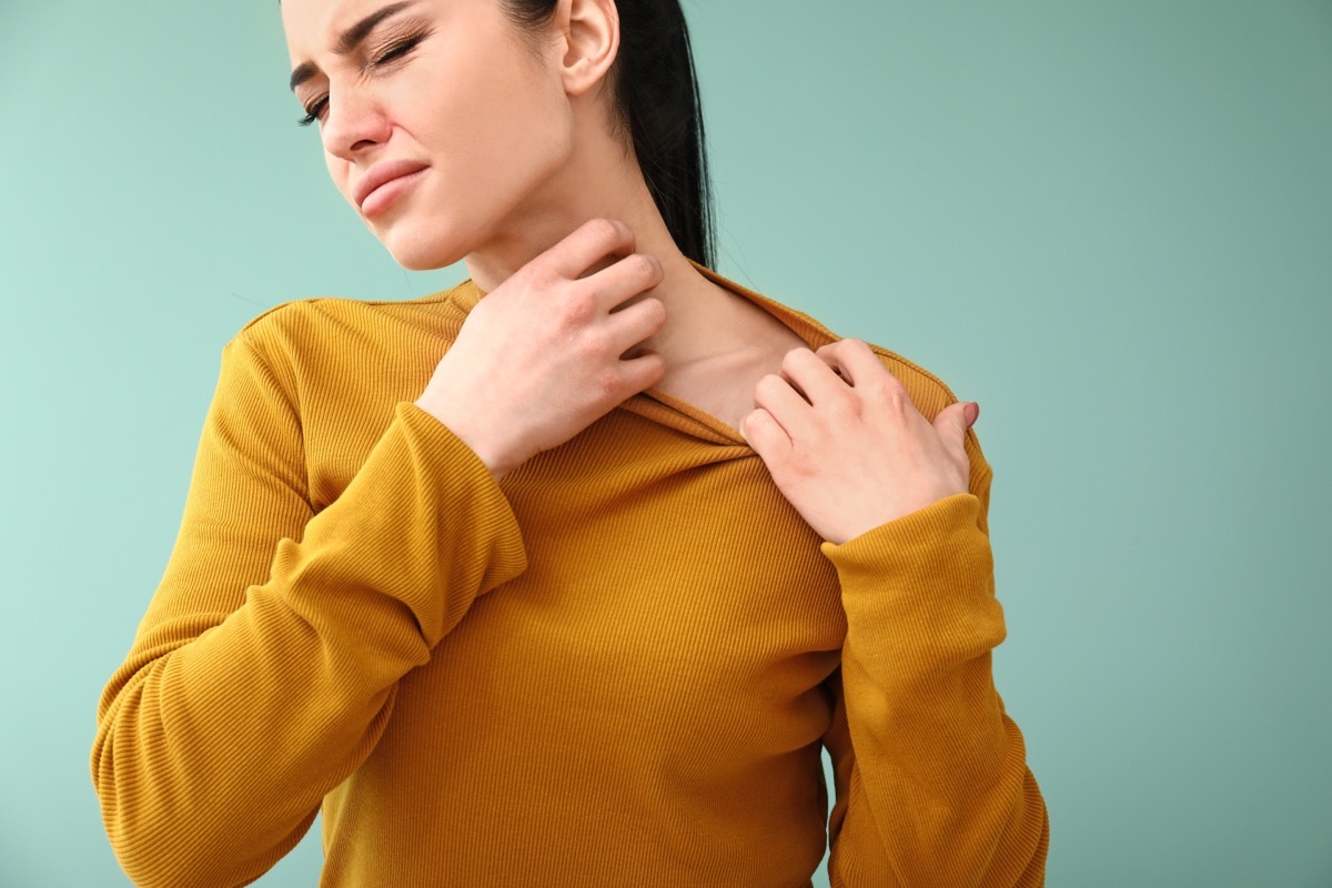 woman scratching rash on skin