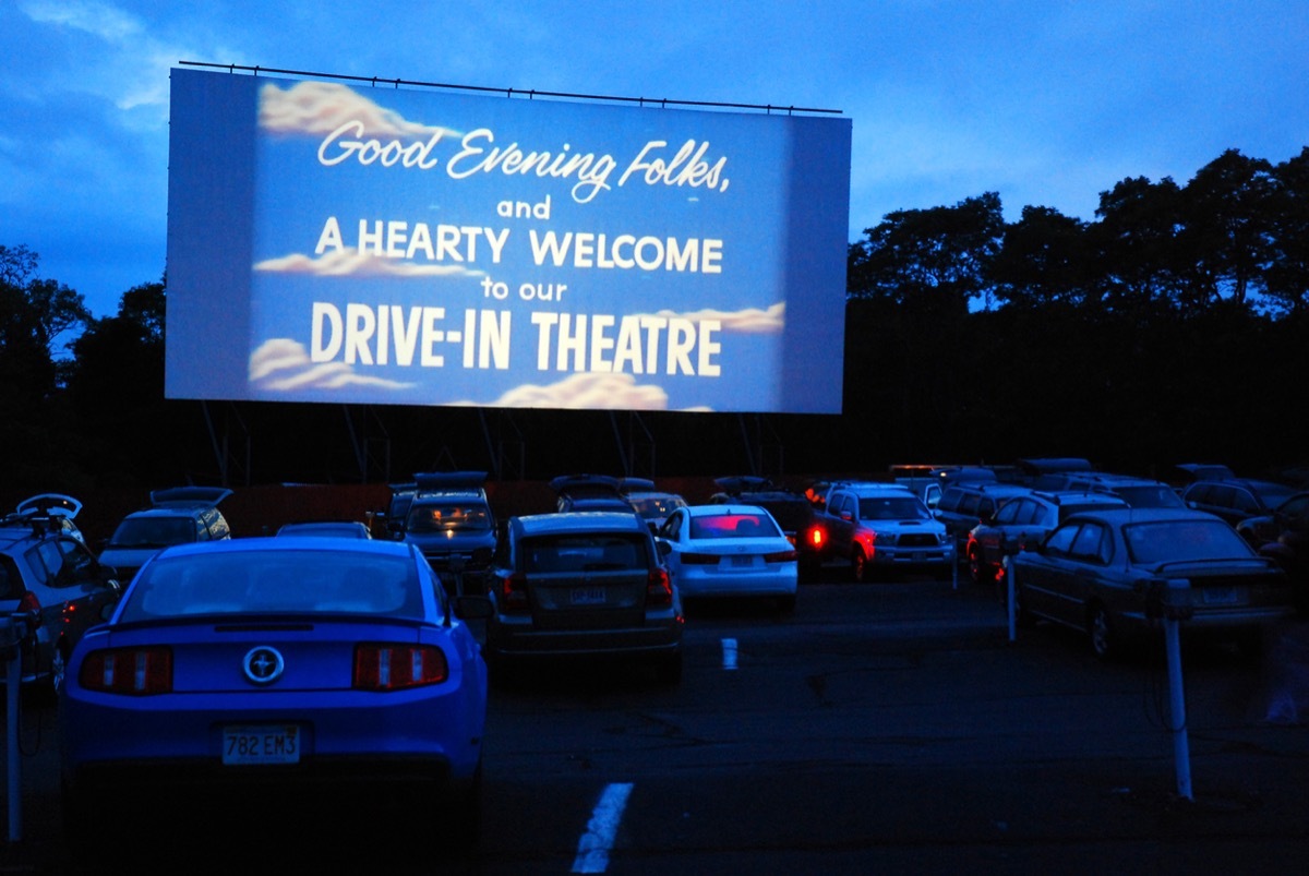 drive-in theater screen welcoming moviegoers in cars