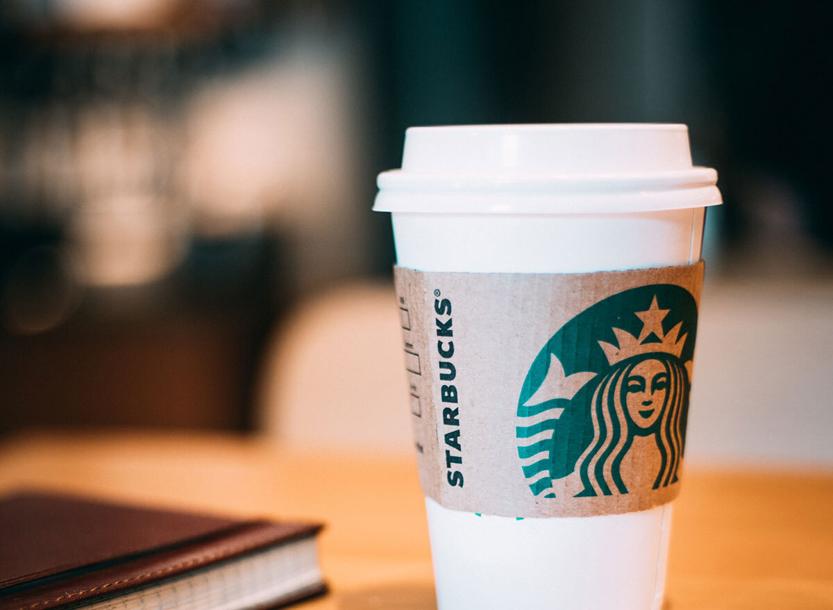 Starbucks cup of coffee at a table with a notepad