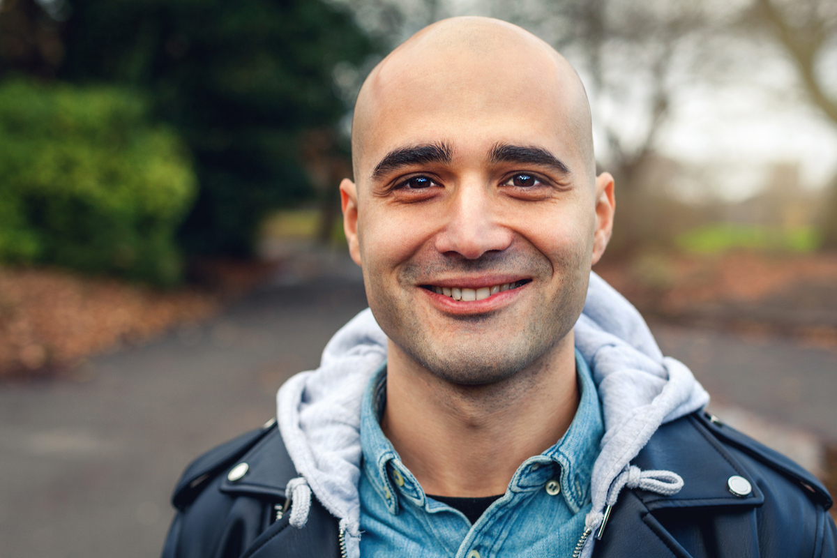 Smiling young man with casual clothes at the park.