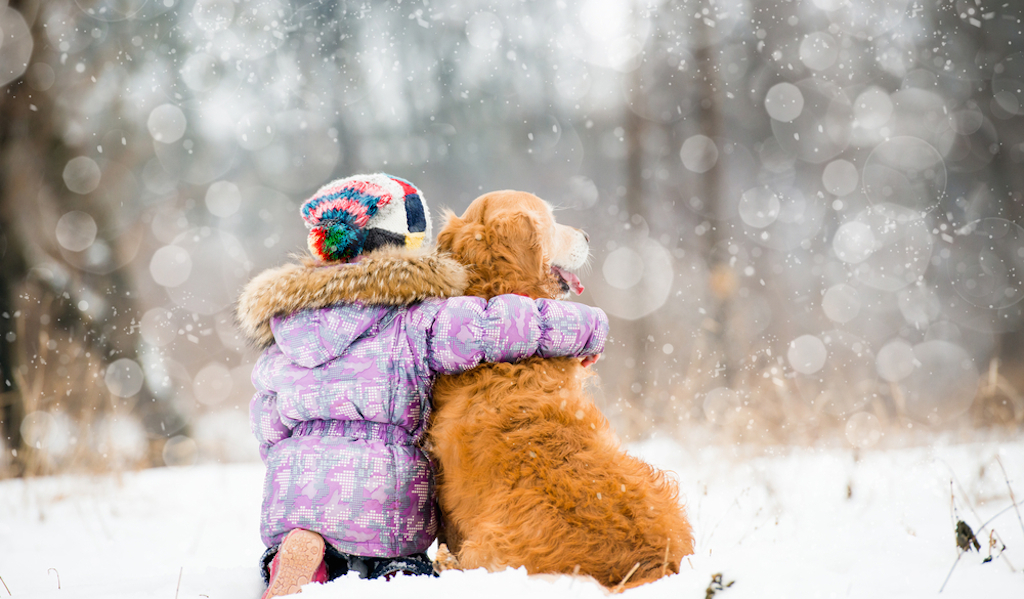 little girl hugging dog in winter, skills parents should teach kids