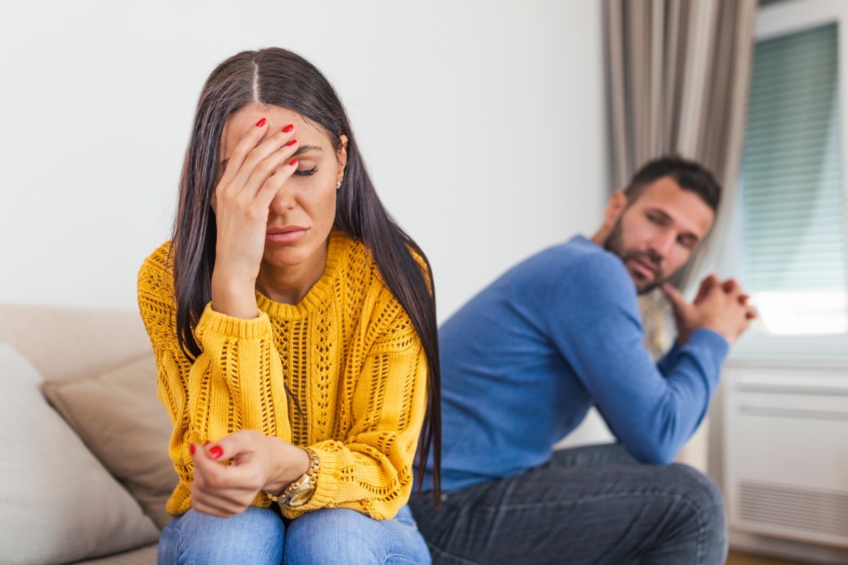 couple sitting on couch arguing