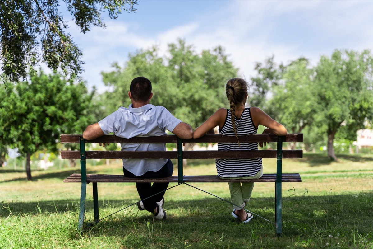 Couple sitting together on a bench in the park