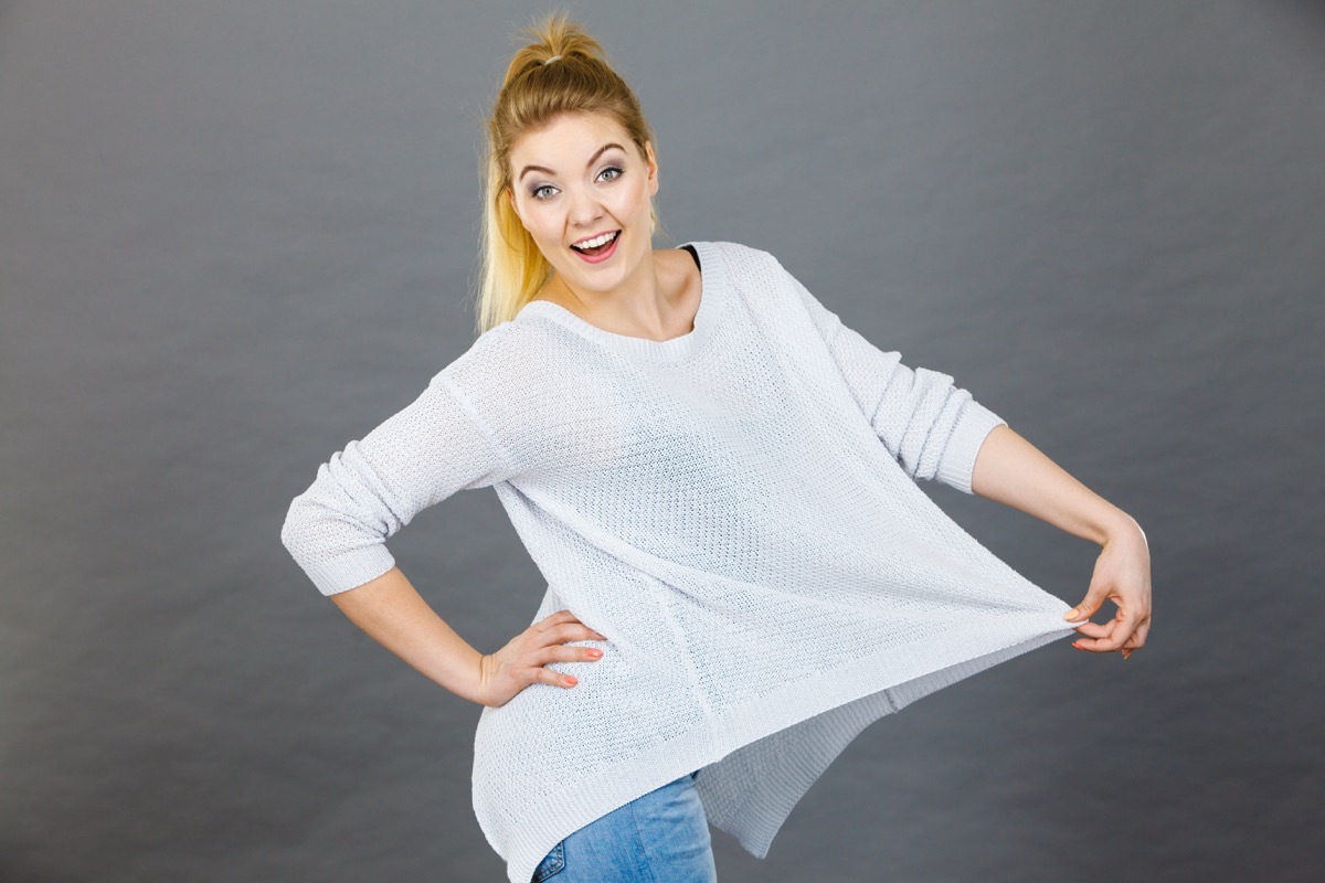 Woman wearing loose fitting big white shirt