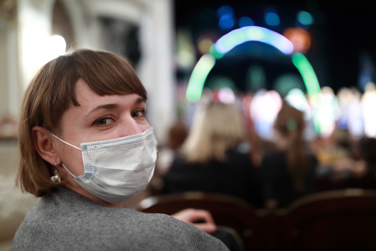 Woman with a mask at an outdoor concert