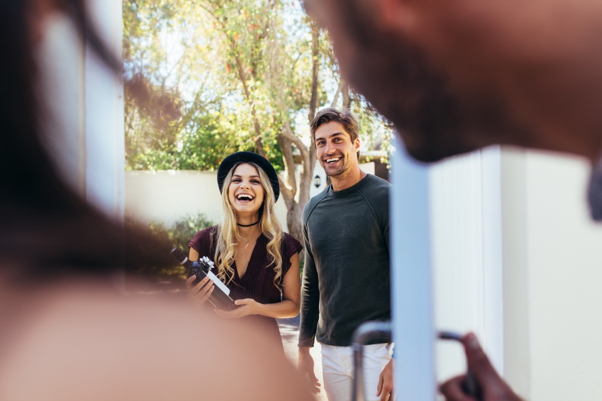 Couple Bringing a Bottle of Wine as a Gift BBQ Etiquette Mistakes