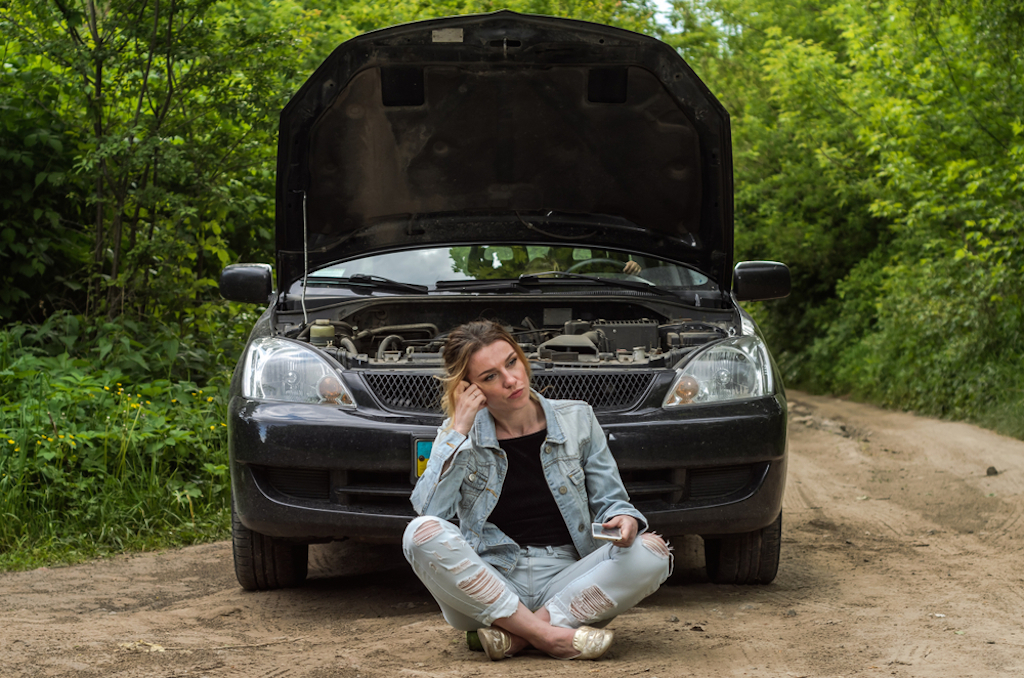 woman next to stalled car