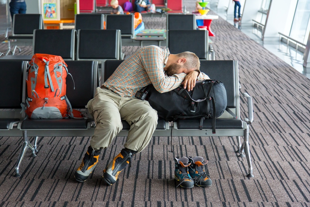 man sleeping at the boarding gate