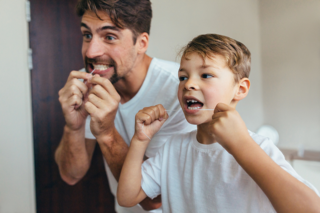 dad and son flossing teeth, how parenting has changed