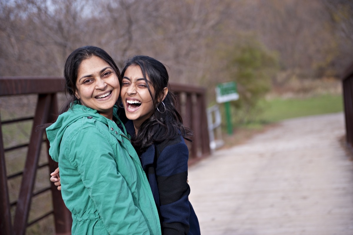 mother and daughter smiling outdoors