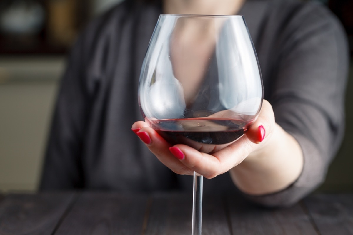 woman holding wine glass, mistakes everyone makes