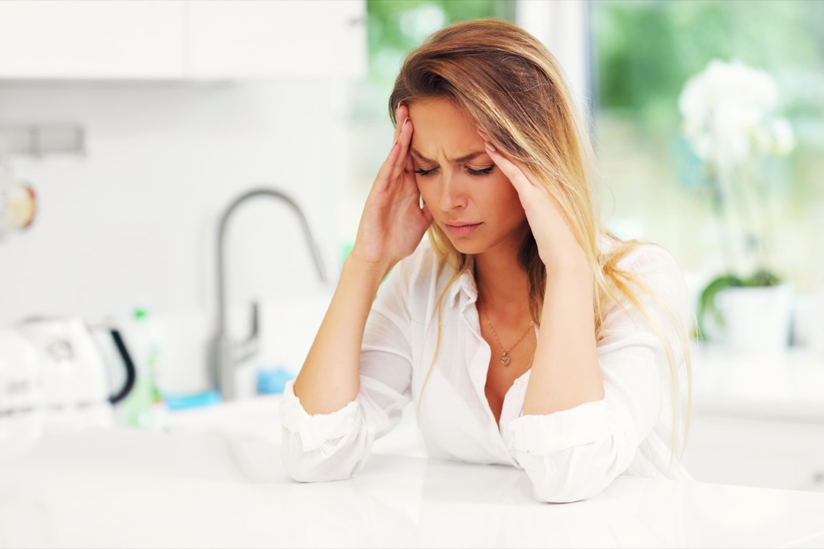 Young sad woman in kitchen