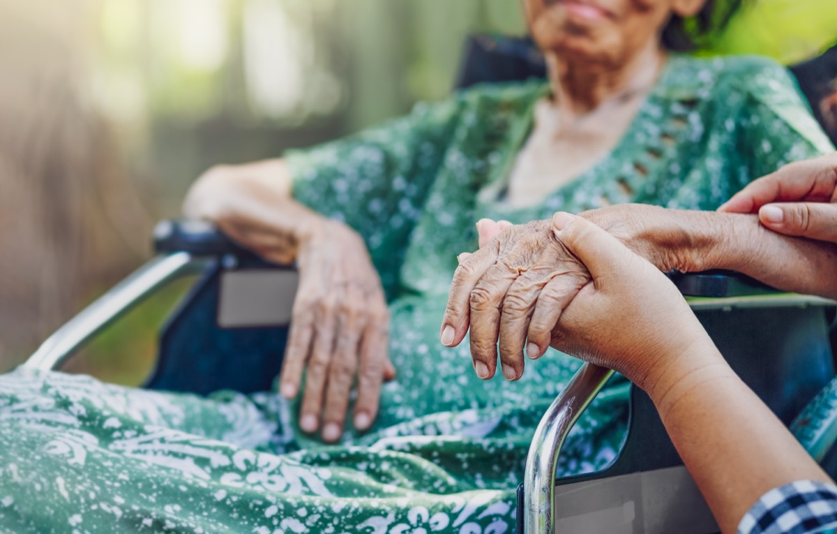 Elderly asian woman on wheelchair at home with daughter take care