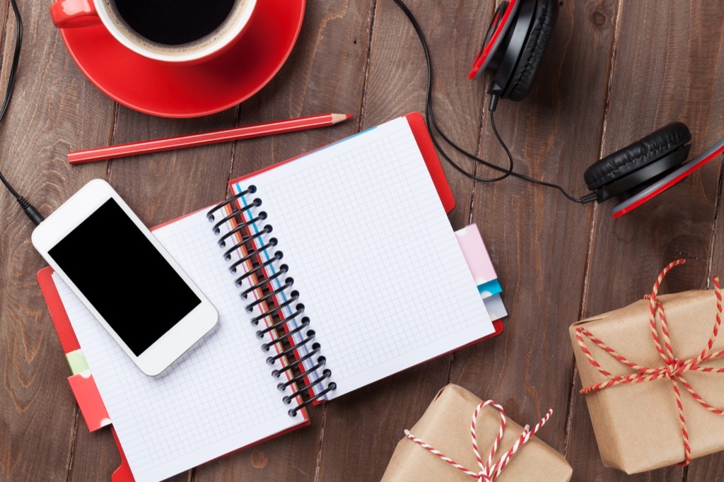 Desk with red cup and red notebook