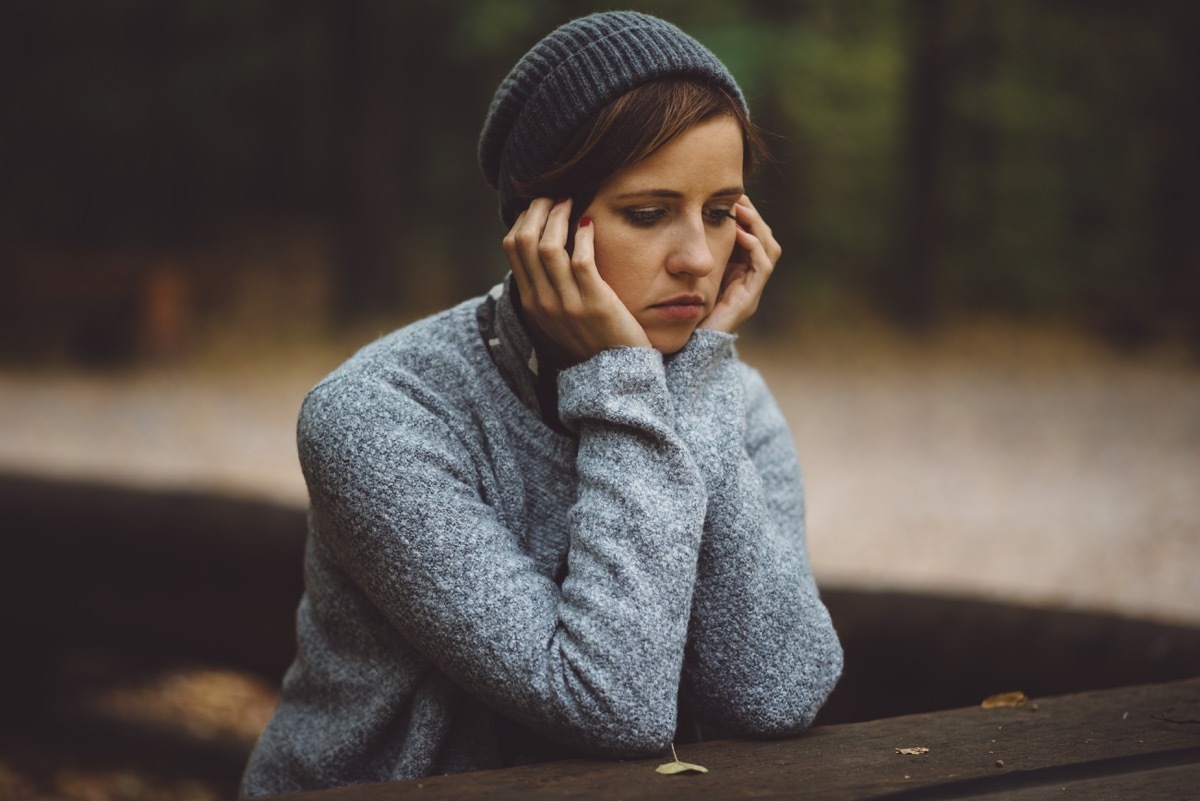 sad woman standing alone