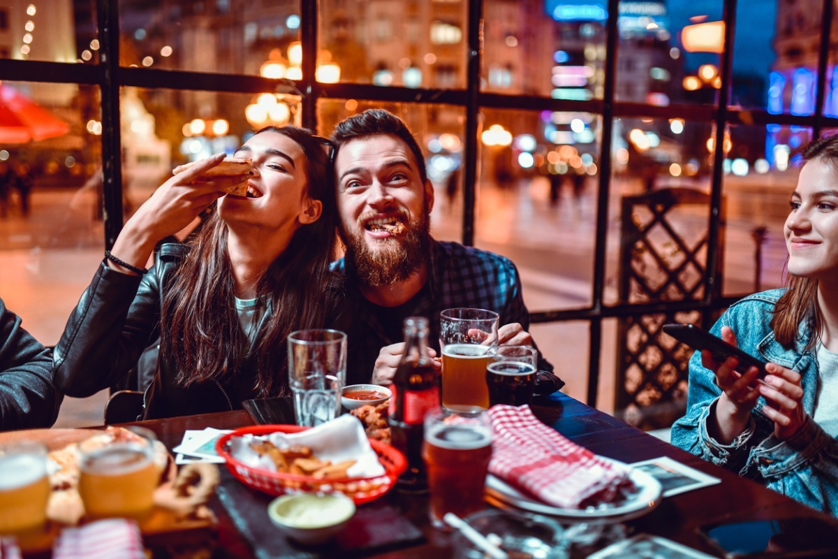 young couple eating pizza