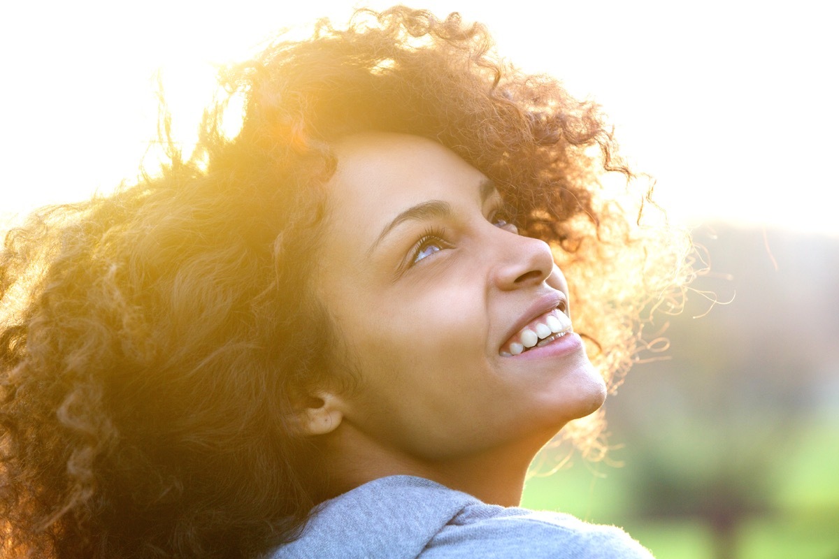 young african american woman smiling and looking up