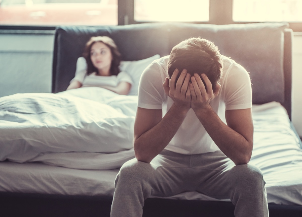 Man stressed in bed