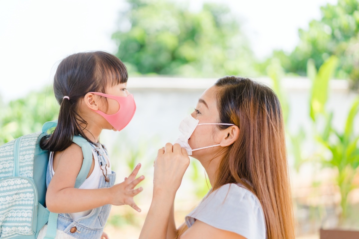 Mother and daughter wearing masks outside