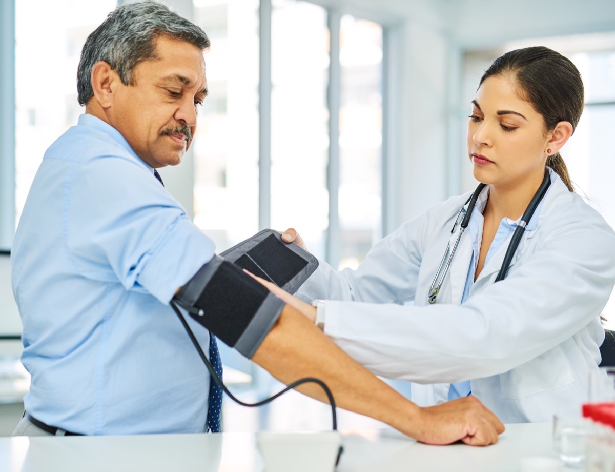 Shot of a doctor checking a patient's blood pressure in a hospital