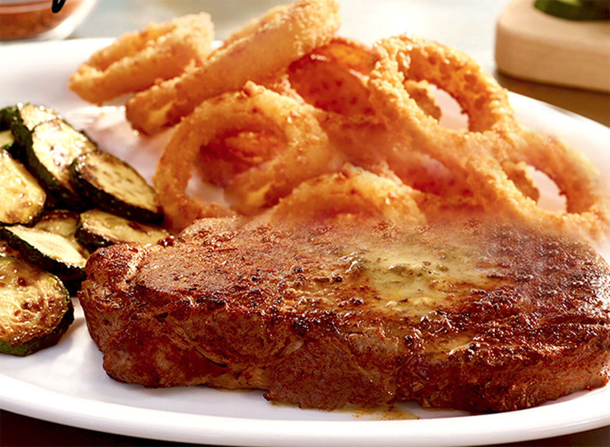 Cajun Ribeye at Ruby Tuesday's with onion rings and zucchini