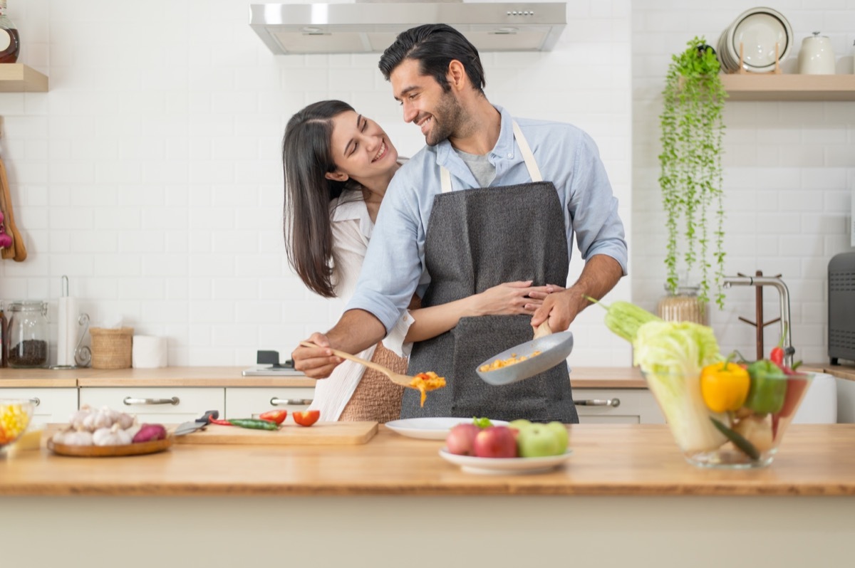 husband cooking dinner for wife