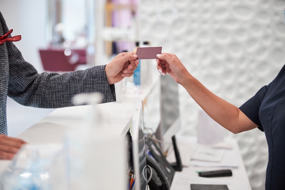 Cropped copy-space photo of a blank plastic card being passed from one person to another